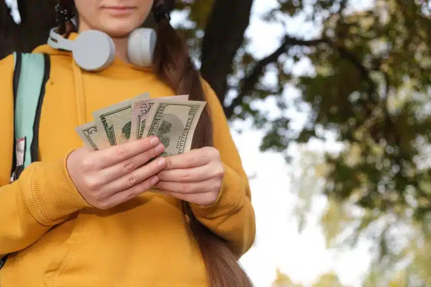 Next Generation Wealth Planning - teenager holding cash