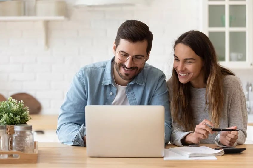 Next Generation Financial planning - young couple looking at finances on their laptop
